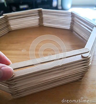 Glueing popsicle sticks Stock Photo