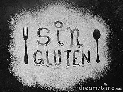 Gluten free flour with text gluten free in Spanish language with spoon and fork silhouette made with flour on dark texture Stock Photo