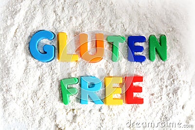 Gluten free text spelled out with colored letters in white flour Stock Photo