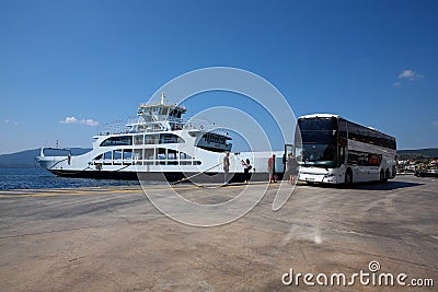 Glyfa village, Greece - August 15, 2023: Ferryboat docked at the harbour of Glyfa village in Greece. Passangers entering bus and Editorial Stock Photo