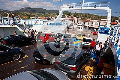 Glyfa village, Greece - August 15, 2023: Vehicles and people travelling from Evia island exiting ferryboat at the harbour of Glyfa Editorial Stock Photo