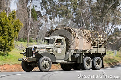 1941 GMC CCKW-353 Troop carrier driving on country road Editorial Stock Photo