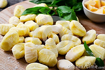 Gnocchi, Fresh Uncooked Potato Gnocchi on Wooden Board, Italian Cuisine Stock Photo