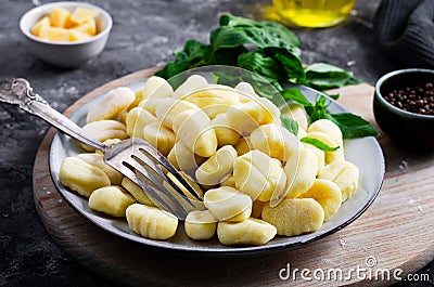 Gnocchi, Fresh Uncooked Potato Gnocchi on Wooden Board, Italian Cuisine Stock Photo