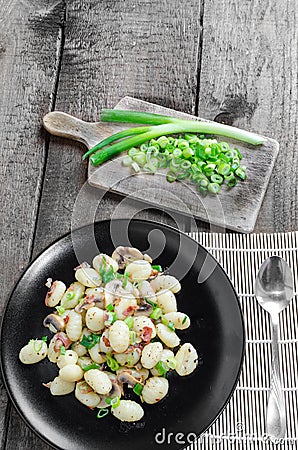 Gnocchi pasta with ham, spring onion Stock Photo