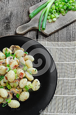 Gnocchi pasta with ham, spring onion Stock Photo