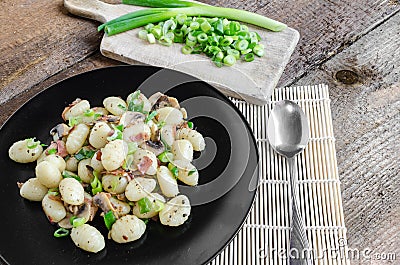 Gnocchi pasta with ham, spring onion Stock Photo