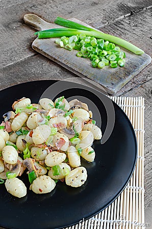 Gnocchi pasta with ham, spring onion Stock Photo