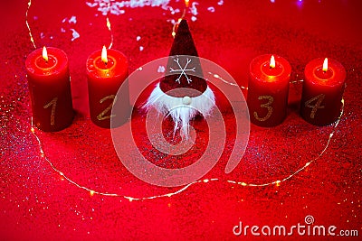 Gnom with 4 candles on a red background Stock Photo