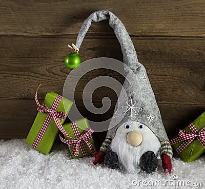 Gnom santa with green and red christmas presents in rustic count Stock Photo