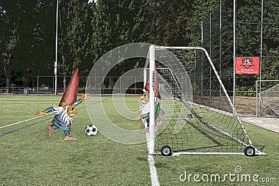 A gnome playing soccer tries to score a goal Stock Photo