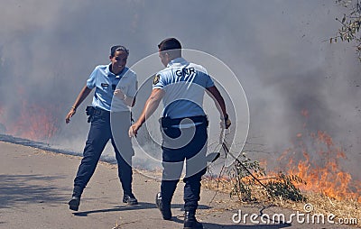 GNR police officers are fighting against the flames Editorial Stock Photo