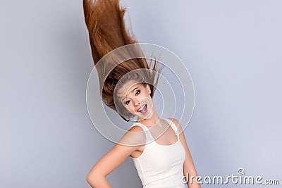 Go crazy and dream big! Dreamy charmed young blond lady in casual outfit is is so happy and funky, her hair is flying in Stock Photo