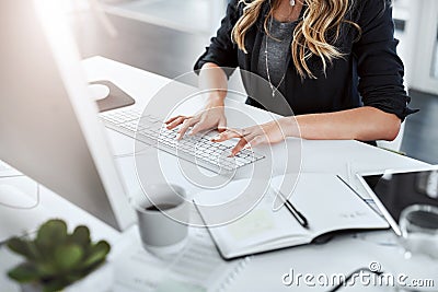 Go getter hands hard at work. a businesswoman using a computer at her desk in a modern office. Stock Photo