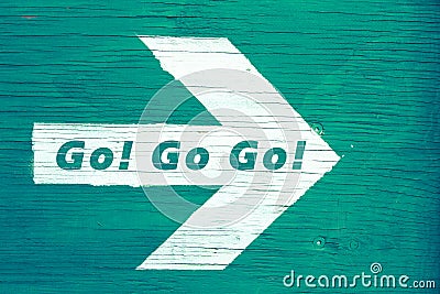 `Go! Go Go!` text written on a white directional arrow Stock Photo