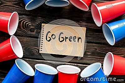 Go green. Eco concept and injunction on the use of plastic flatware on wooden background top view Stock Photo