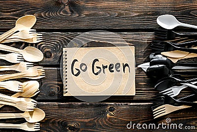 Go green. Eco concept and injunction on the use of plastic flatware on wooden background top view Stock Photo