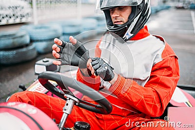 Go-kart driver in helmet on karting speed track Stock Photo