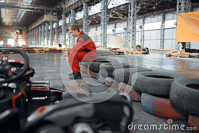 Go kart racer sitting on tires, karting auto sport Stock Photo