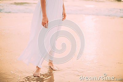 Goa, India. Close Legs And Hands Of Young Woman In White Dress Near Sea Ocean In Sunny Time Stock Photo