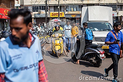 Goa, India, February 2023. Busy heavy traffic road crowded with people, motorcyclists, trucks near parking, shops. Editorial Stock Photo