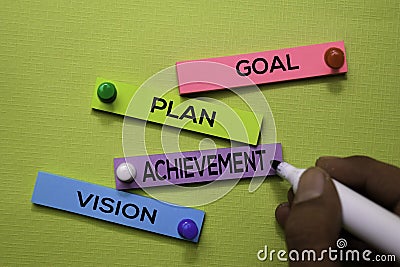 Goal, Plan, Achivement, Vision text on sticky notes isolated on green desk. Mechanism Strategy Concept Stock Photo