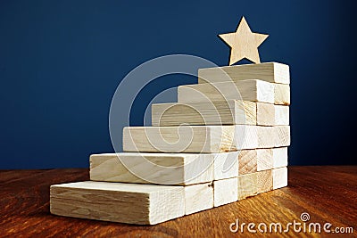 Goal setting and achievement. Star and stairs from wood Stock Photo