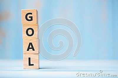 GOAL wooden cubes on blue table background with copy space for text. Business, Mission, Core Value and Solution concept Stock Photo