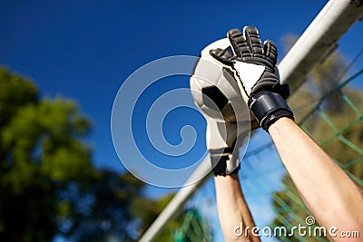 Goalkeeper with ball at football goal on field Stock Photo