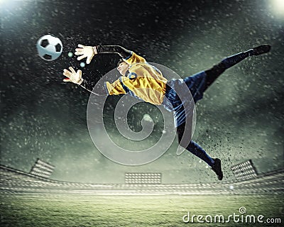 Goalkeeper catches the ball Stock Photo