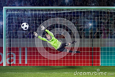 Goalkeeper kid saving in jump on a crowded stadium Stock Photo