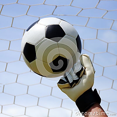 Goalkeeper's hands hitting foot ball Stock Photo