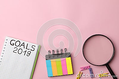goals 2019. text in a notebook with colored stickers and a magnifying glass on a bright pink background Stock Photo