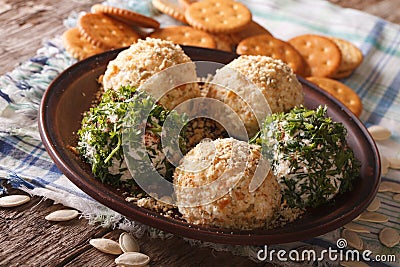 Goat Cheese balls with crackers, herbs and pumpkin seeds close-up. horizontal Stock Photo