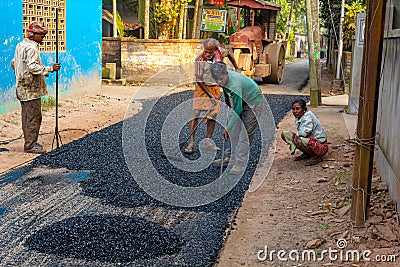 Male workers build road with asphalt Editorial Stock Photo