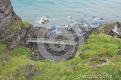 The Gobbins, Northern Ireland-July 21,2017:A view from a cliff to one of the bridge along a dramatic walkway in Europe and the fam Editorial Stock Photo