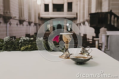 Goblet of wine on table during a wedding ceremony nuptial mass. Religion concept. Catholic eucharist ornaments for the celebration Stock Photo