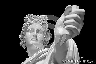 God Apollo bust sculpture. Ancient Greek god of Sun and Poetry Plaster copy of a marble statue isolated on black Stock Photo