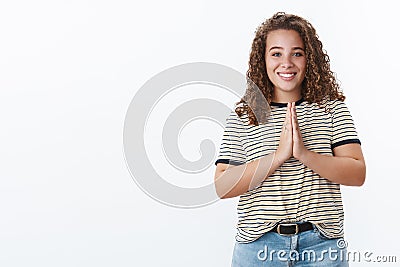 God hear us. Charming hopeful happy relieved young chubby curly-haired girl blue eyes cupped hands together pray gesture Stock Photo