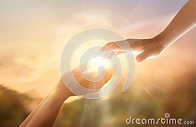 God`s helping hand with the white cross on sunset background. Da Stock Photo