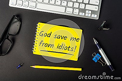 God save me from idiots - message on office workplace. Watch out for stupid people Stock Photo