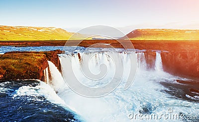 Godafoss waterfall at sunset. Fantastic landscape. Beautiful cumulus clouds. Iceland Europe Stock Photo