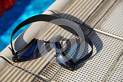 Goggles for swimming on a pool side Stock Photo