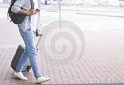 Tourist walking to transportation stop with luggage Stock Photo