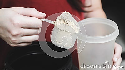 Going to pour casein protein powder into the cup. Stock Photo