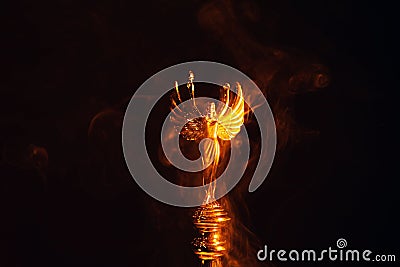 Gold angel statue smoke dark background Stock Photo