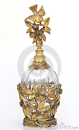 Gold antique vintage perfume bottle bird & dogwood Stock Photo