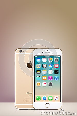 Gold Apple iPhone 7 with iOS 10 on the screen on vertical gradient background with copy space Editorial Stock Photo