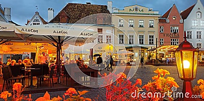 Gold Autumn Rainy evening people umbrellas street cafe city light lamp old town of Tallinn ,Estonia,02,09,2019 cityscape travel t Editorial Stock Photo