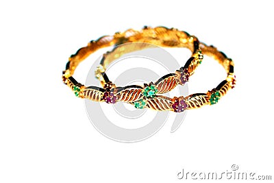 Gold bangles with green and pink rubies Stock Photo